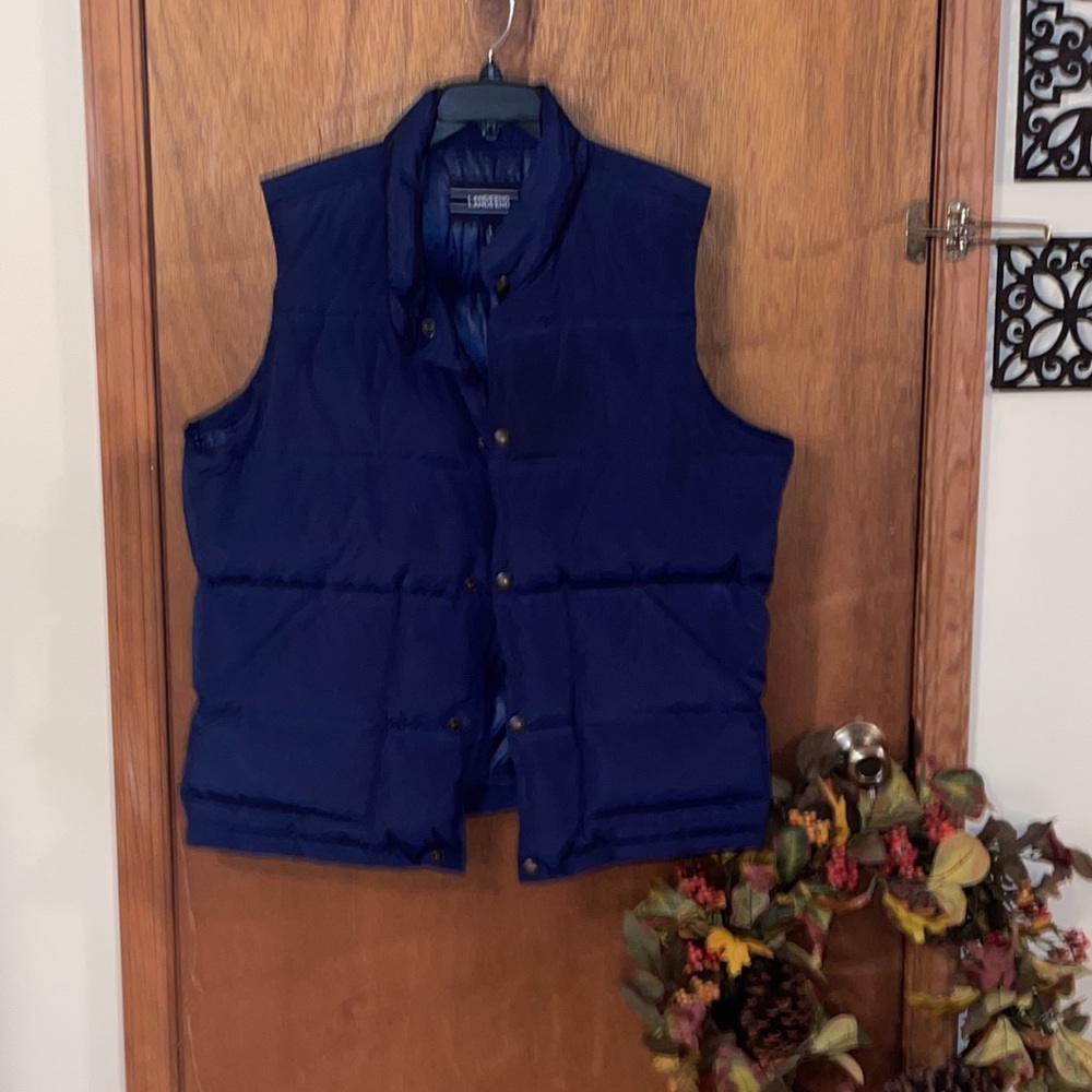 Vest- navy blue, 100% polyester filled, snaps, with pockets.